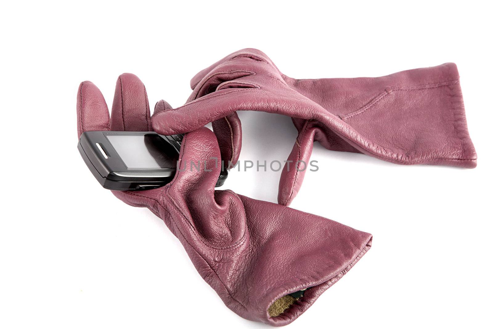Leather gloves compress cellular telephone on a white background