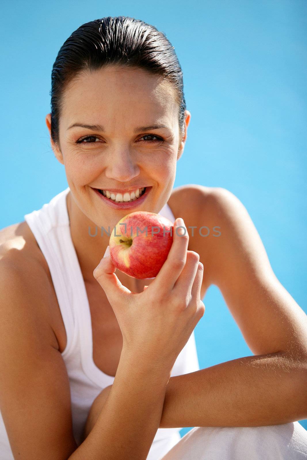 Woman eating an apple by phovoir