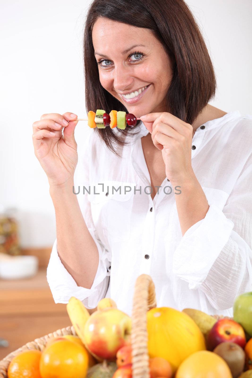 woman eating fruits by phovoir