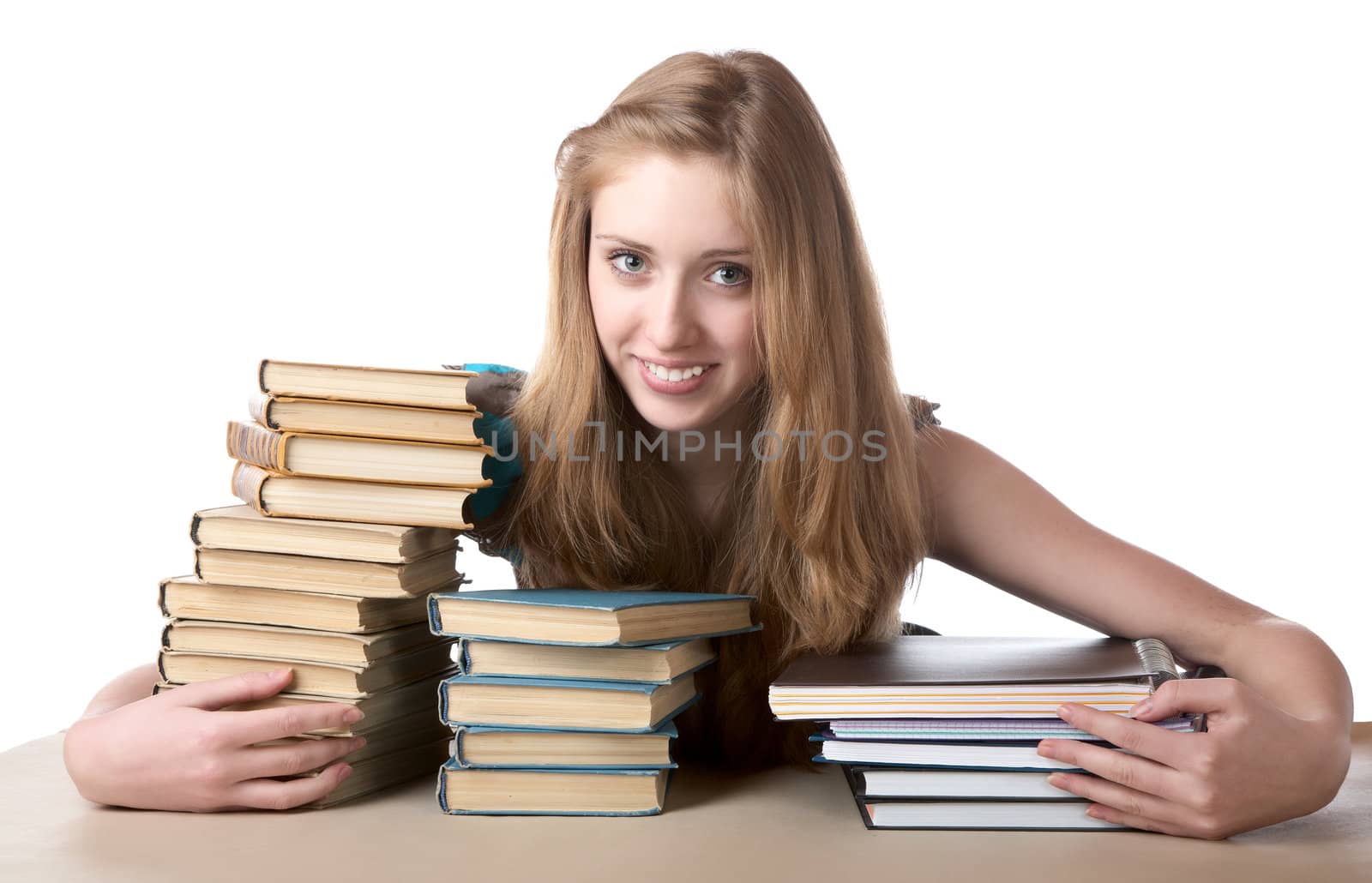 The girl embraces a pile of books and writing-books on  white background