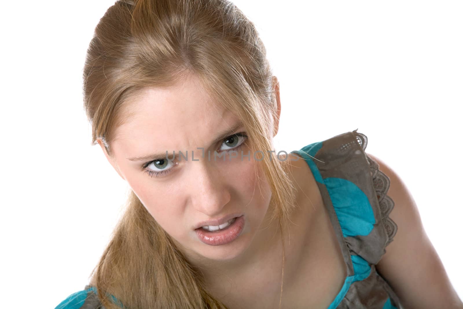 The girl shows discontent on a white background