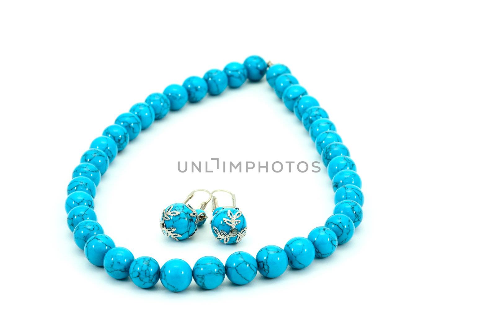 Blue beads and earrings on a white background