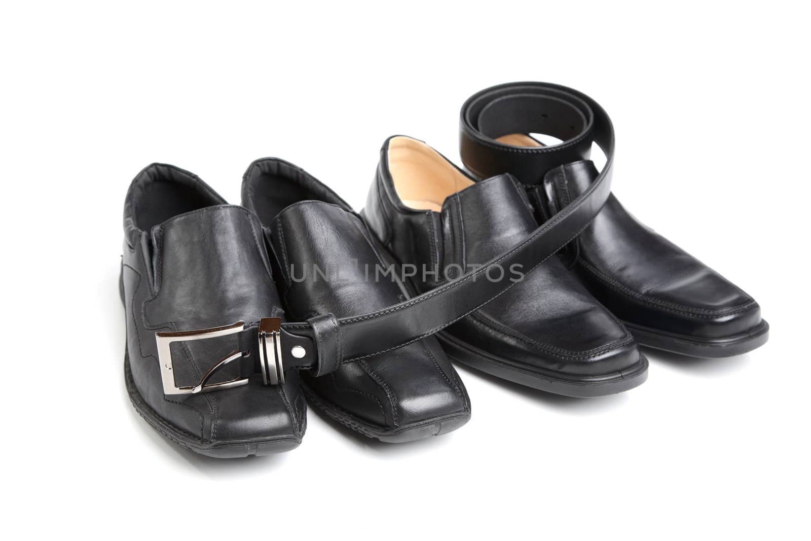 Two pairs black man's shoe and a belt on  white background