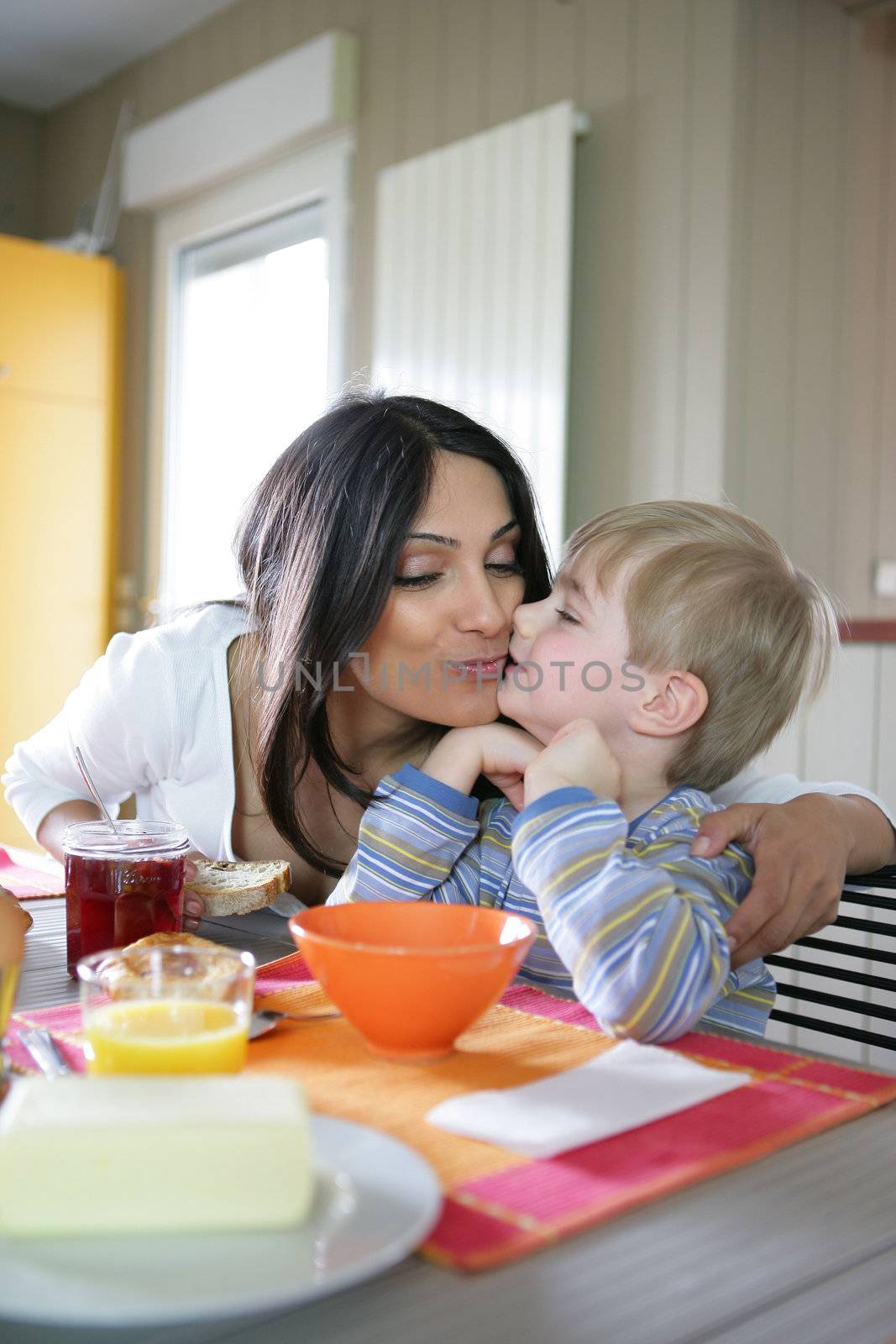 Mother and son in the kitchen by phovoir