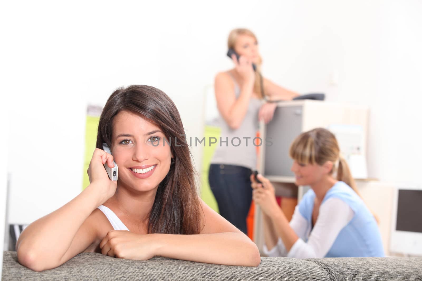 Friends using phones at home