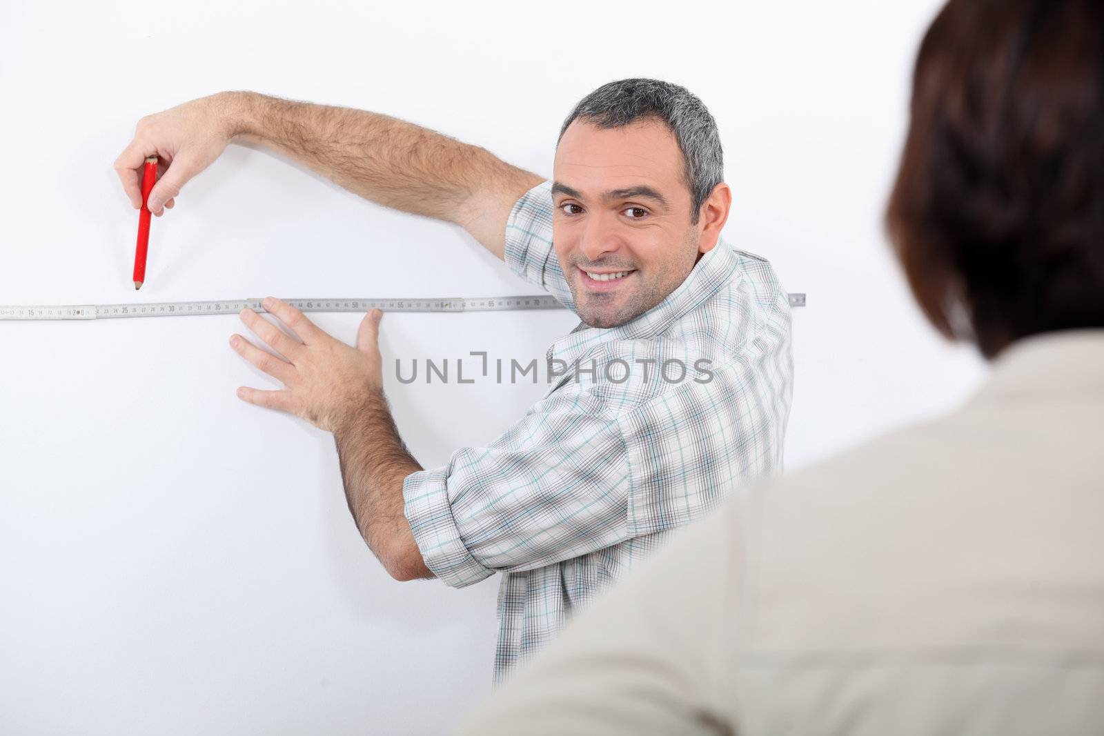 Man drawing line on wall
