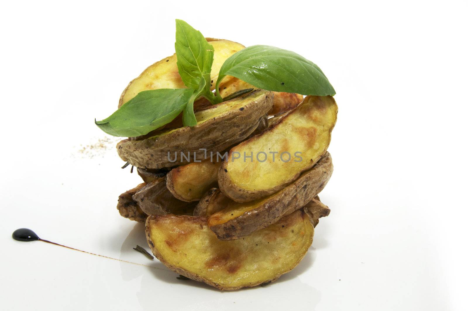 Baked potatoes on a plate decorated with greens