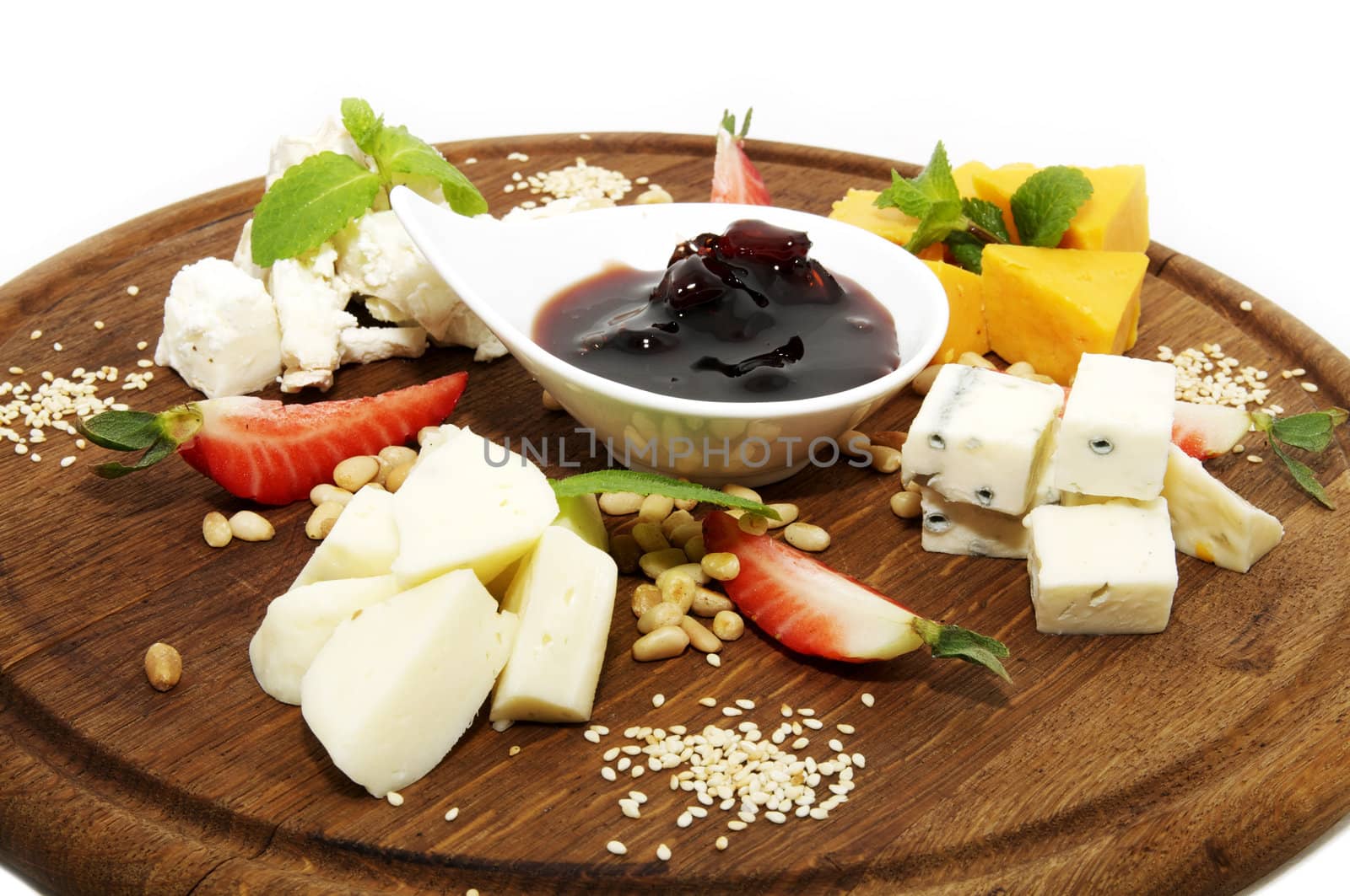 cheese plate with some sauce and cheeses