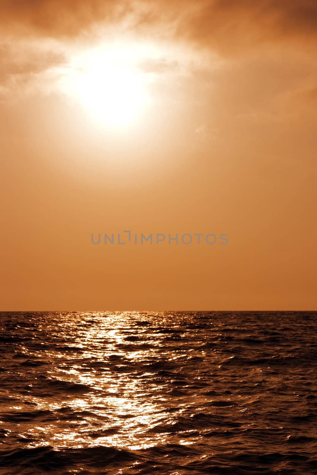 Beautiful sunset above a surface of dark sea waves