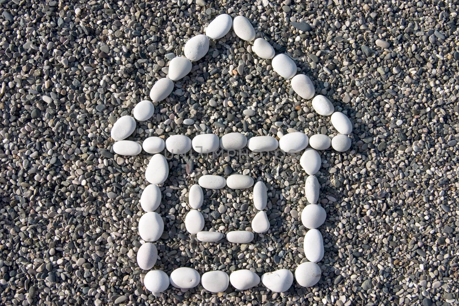 small house made of white stones on a background of a coastal pebble