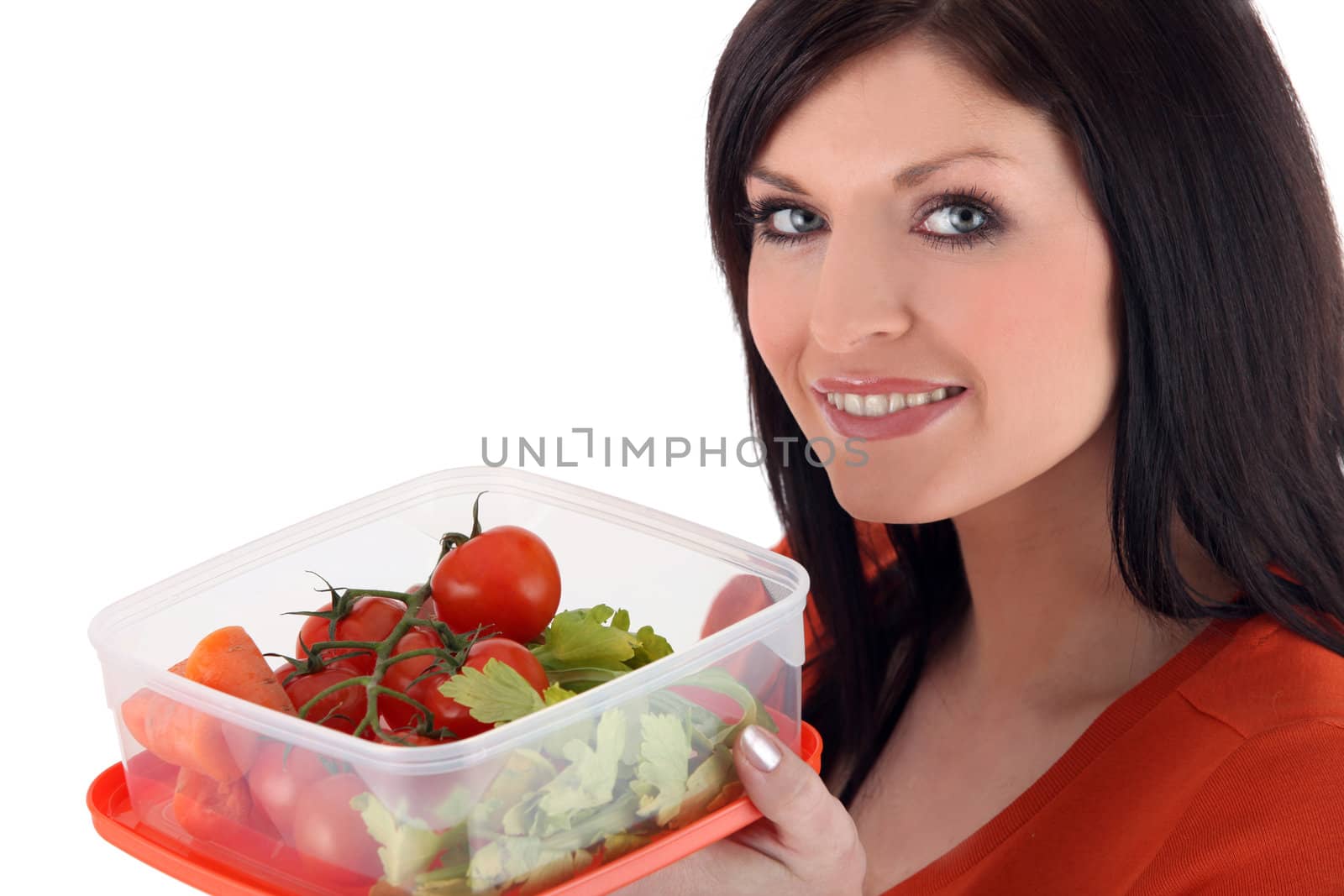 Woman with a plastic lunch box of fresh vegetables