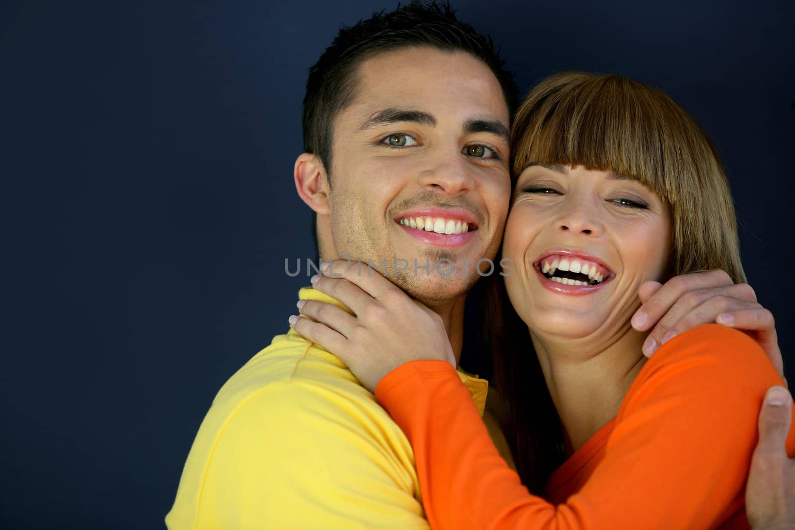 Smiling young couple hugging