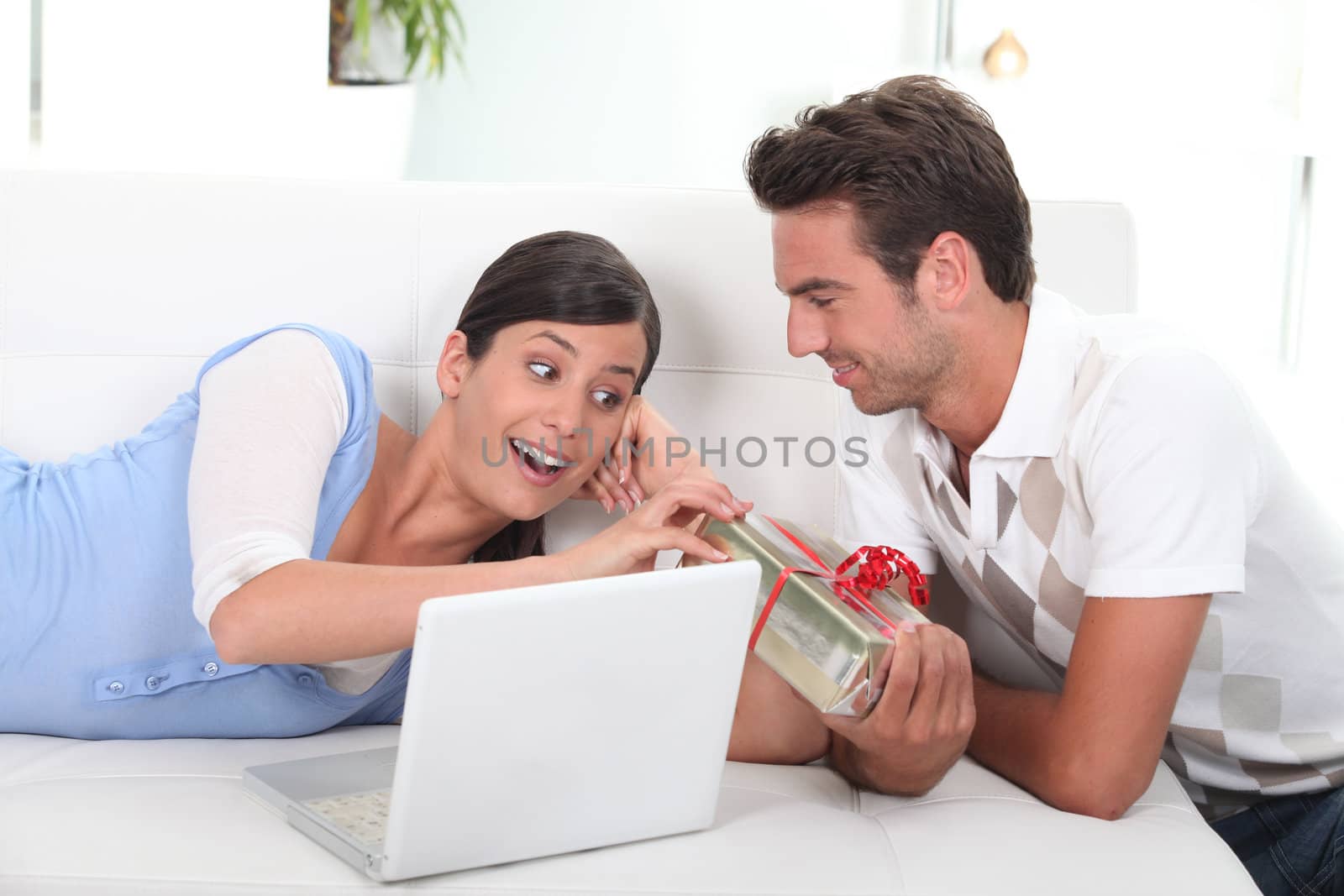 Man offering present to wife by phovoir