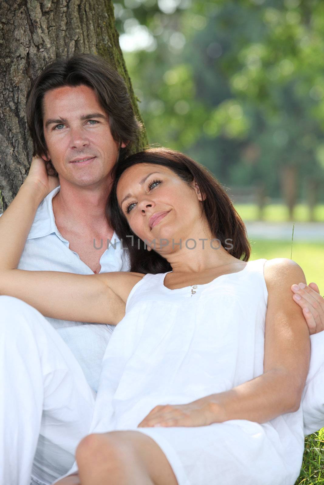 romantic couple in the park by phovoir