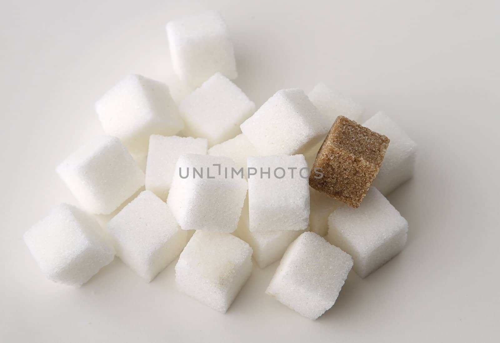 stack of white sugar cube with one brown sugar cube