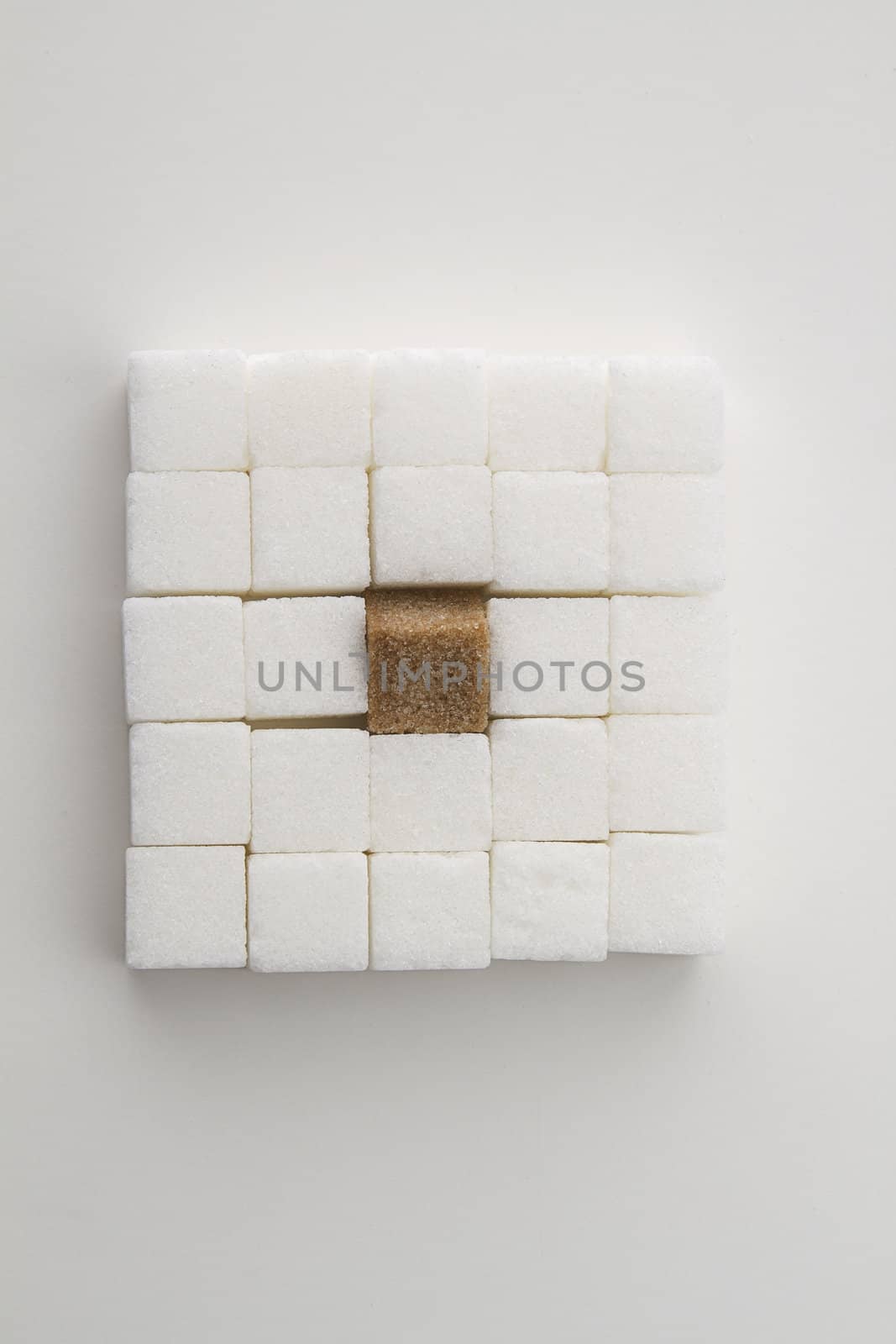 white sugar cube with one brown sugar cube place in a square shape