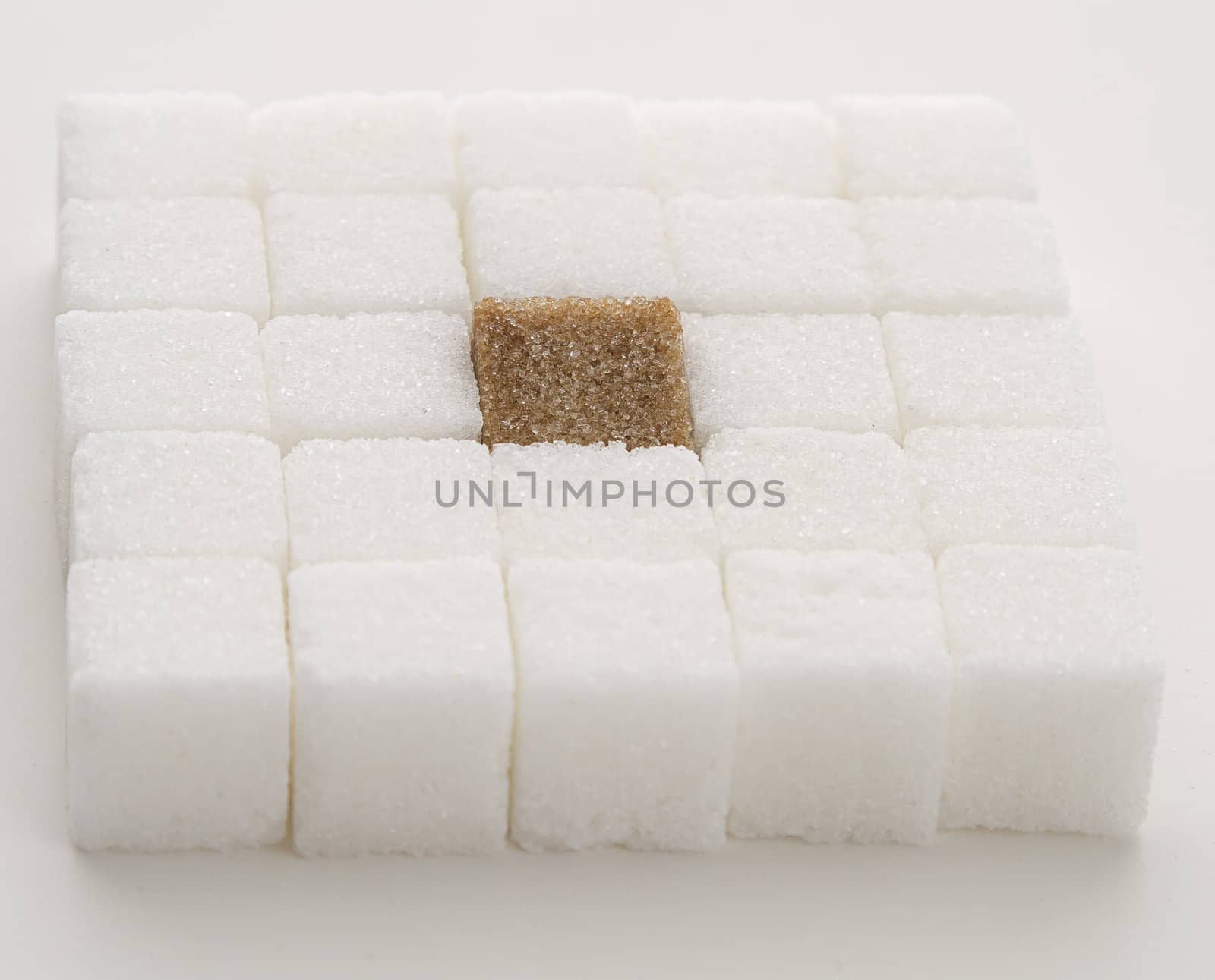 white sugar cube with one brown sugar cube place in a square shape
