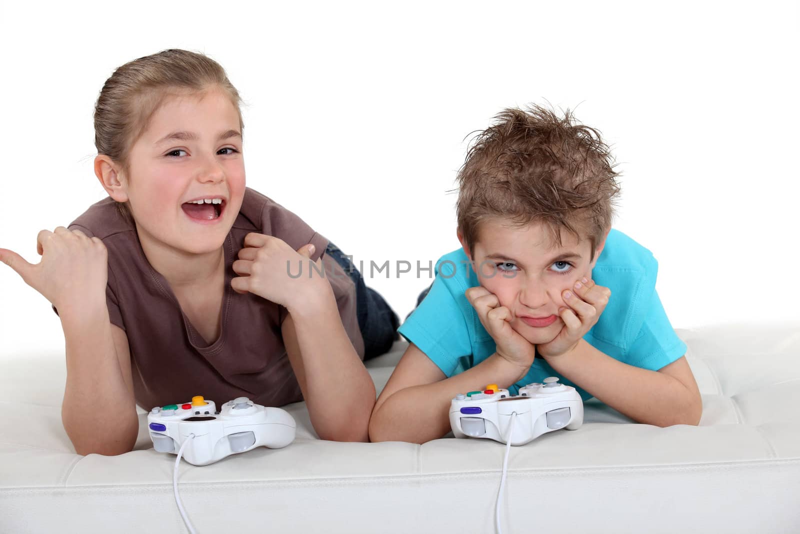 Children playing a games console by phovoir