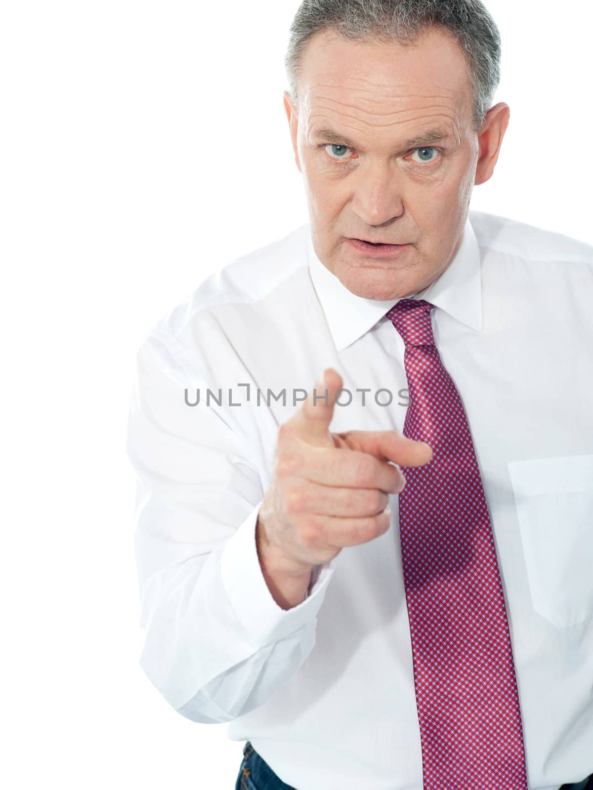 Portrait of an angry middle aged businessman in suit pointing at you isolated over white background