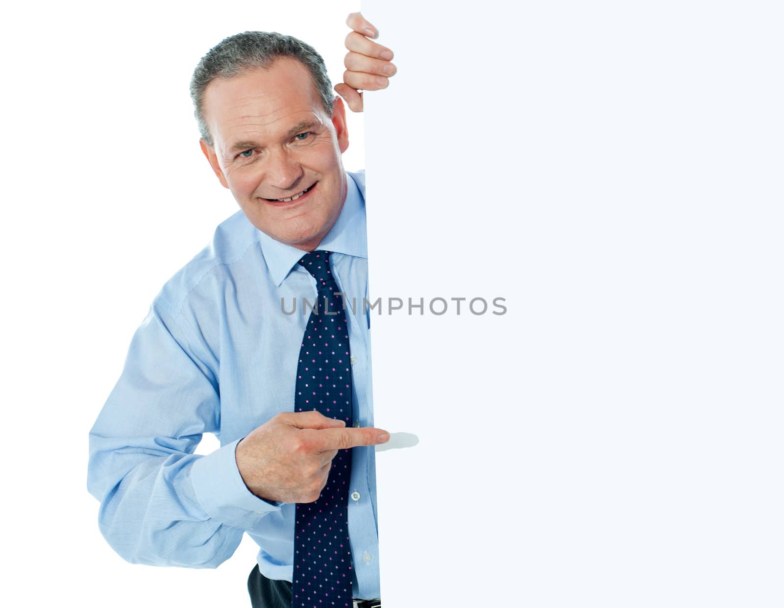 Businessman peeking behind a whiteboard by stockyimages