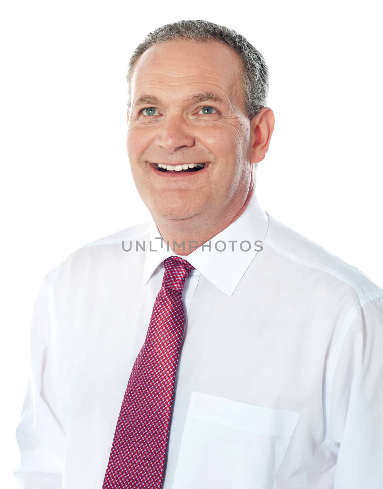 Businessman thinking and smiling. Lost in his own world by stockyimages