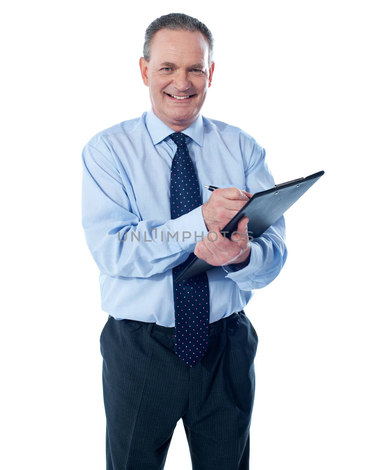 A smiling ethnic businessman writing on a clipboard folder isolated against white background