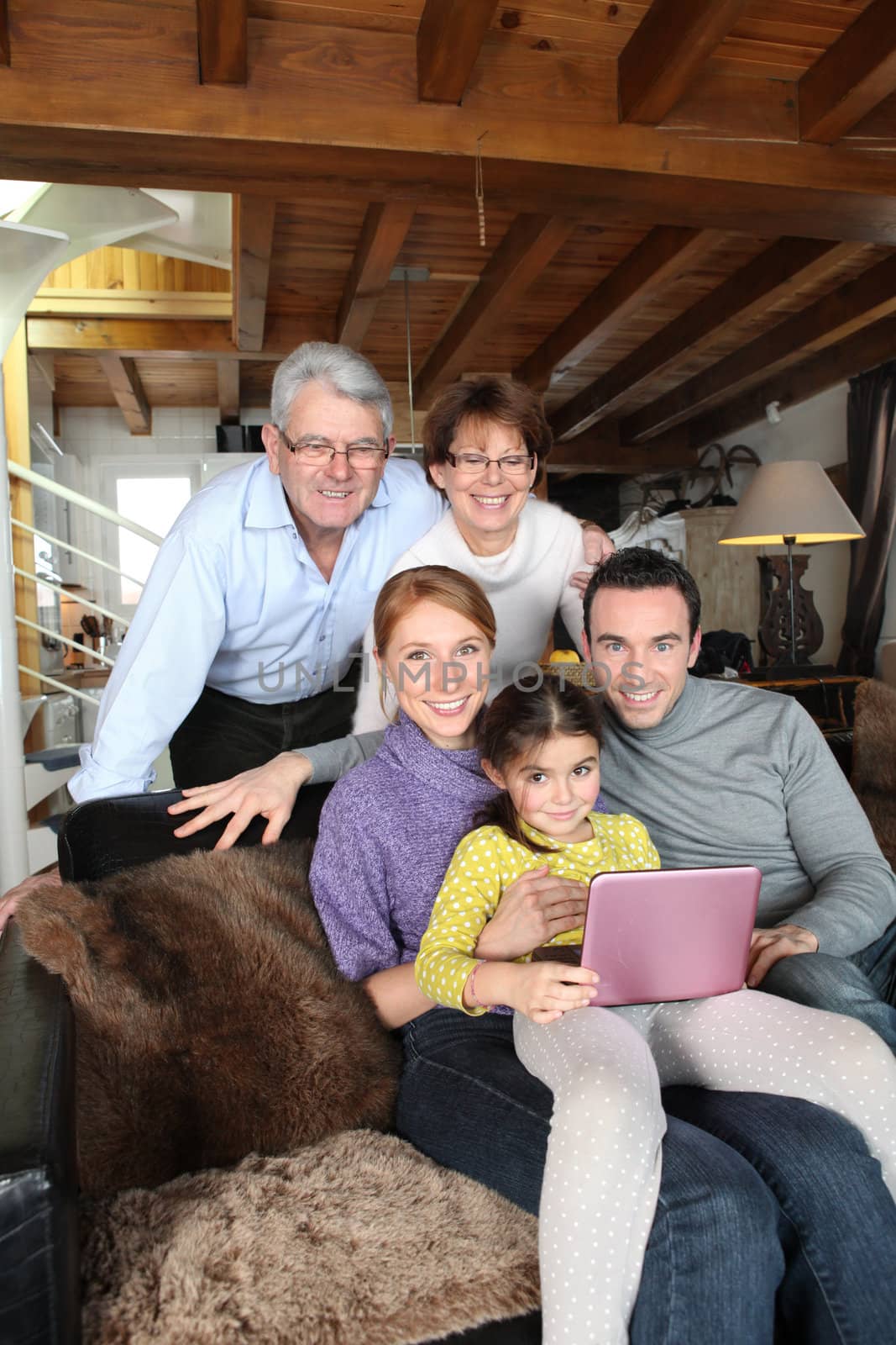Family gathered around laptop