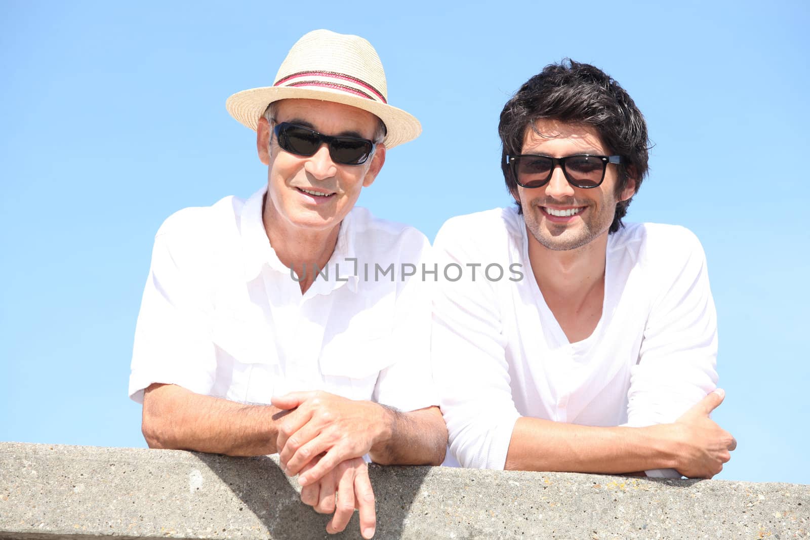 Two men wearing sunglasses in the sunshine by phovoir