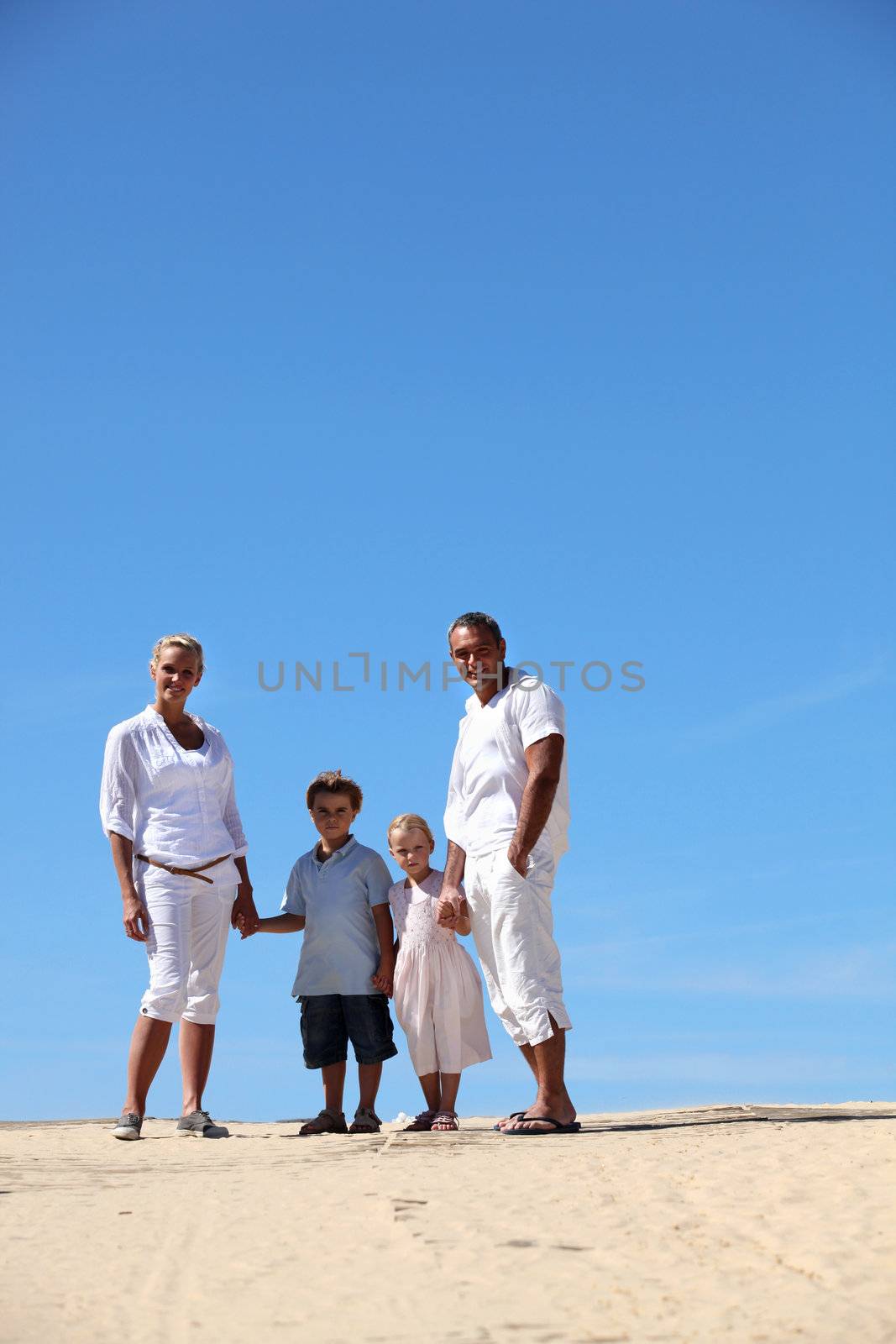 Family at the beach by phovoir