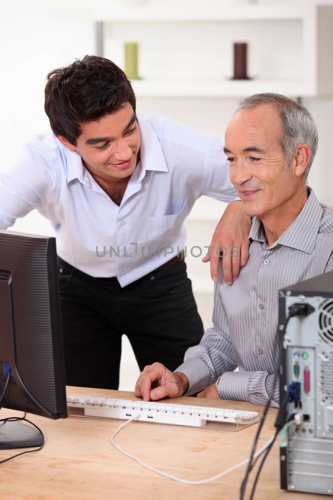 Son helping father with computer