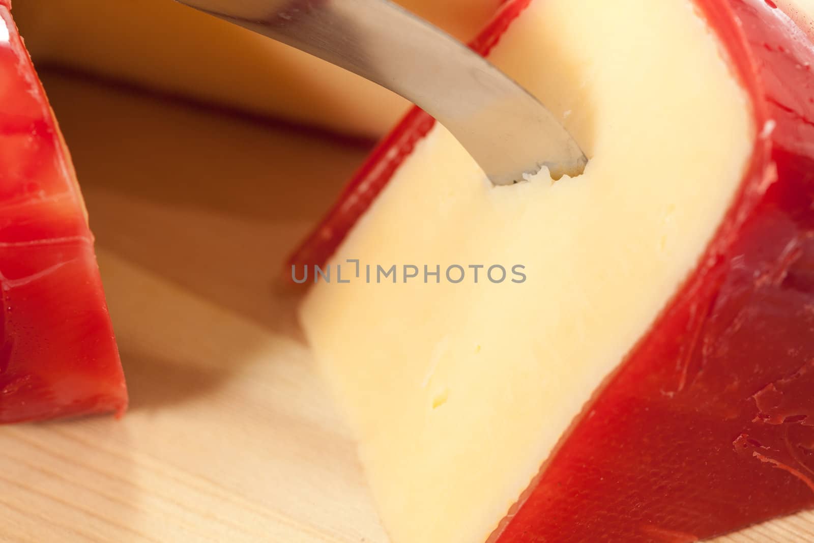 Circular round dutch covered in red wax protection with knife