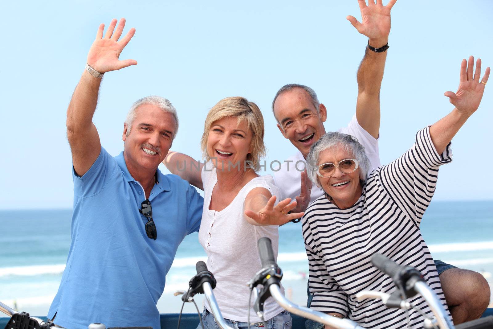 Middle-aged couple on bike ride by the sea