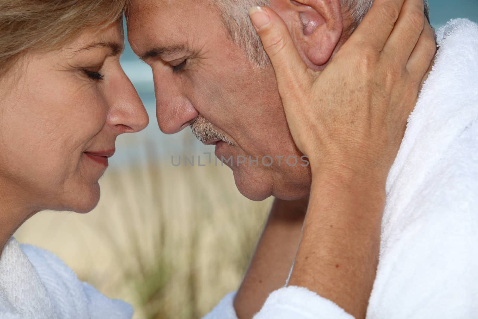 Closeup of a mature couple in love by phovoir