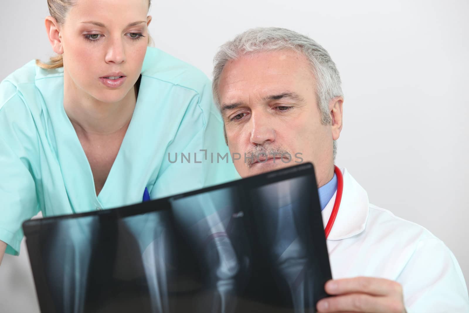 Doctor and nurse looking at an leg xray