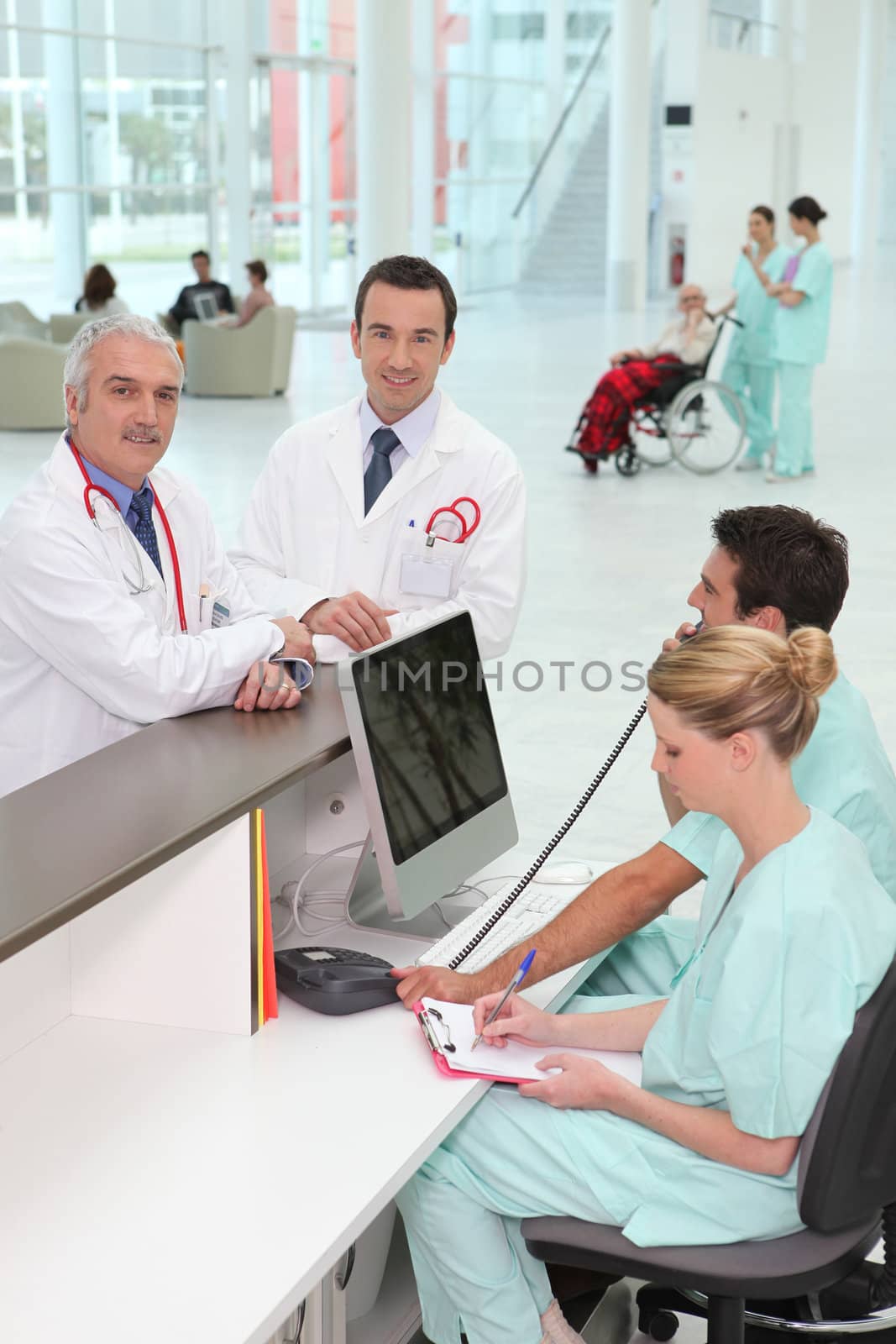 Staff at hospital reception by phovoir