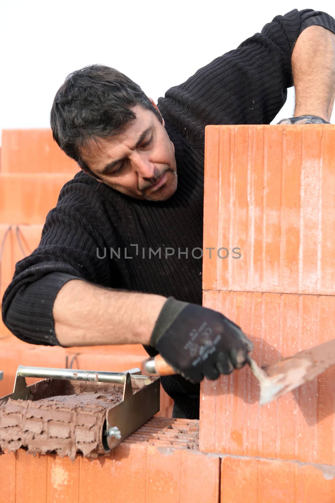 A bricklayer at work by phovoir