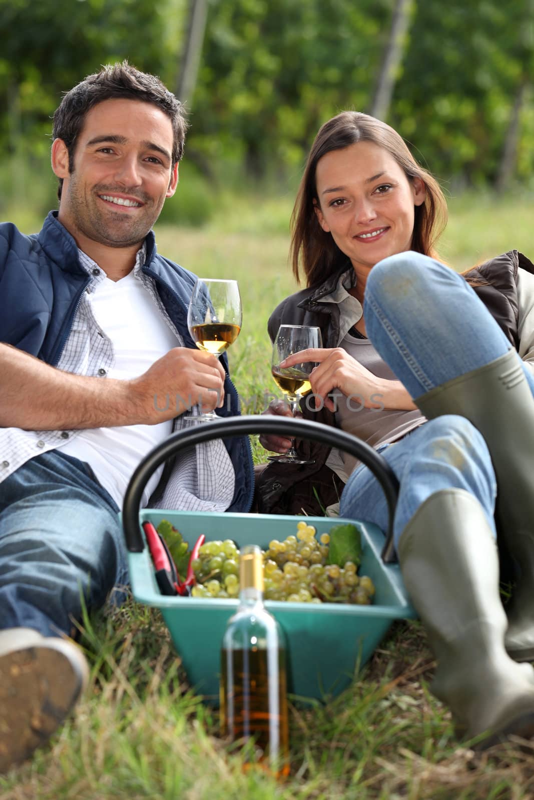 Grapepickers enjoying a glass of wine by phovoir