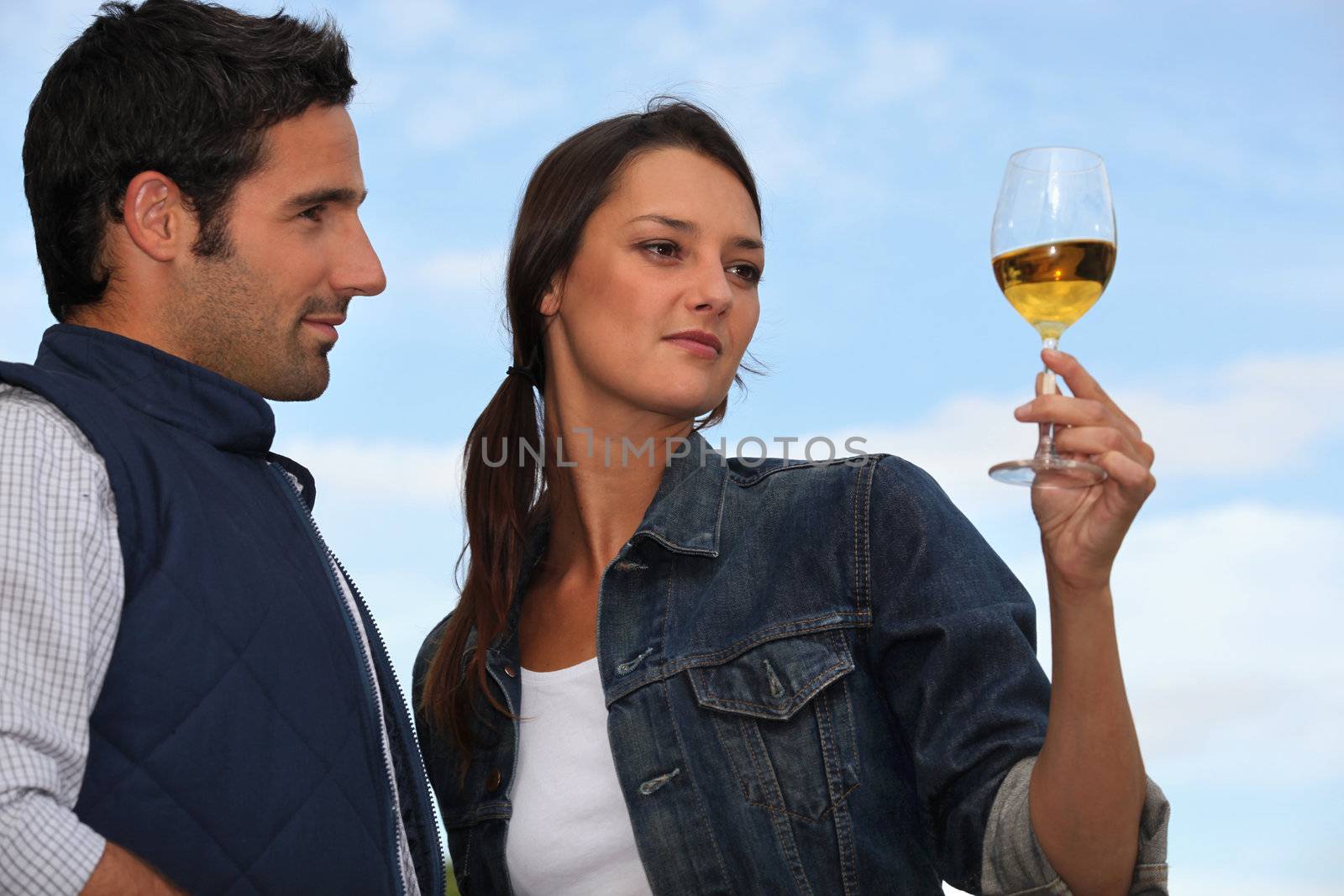 Woman with drink next to man