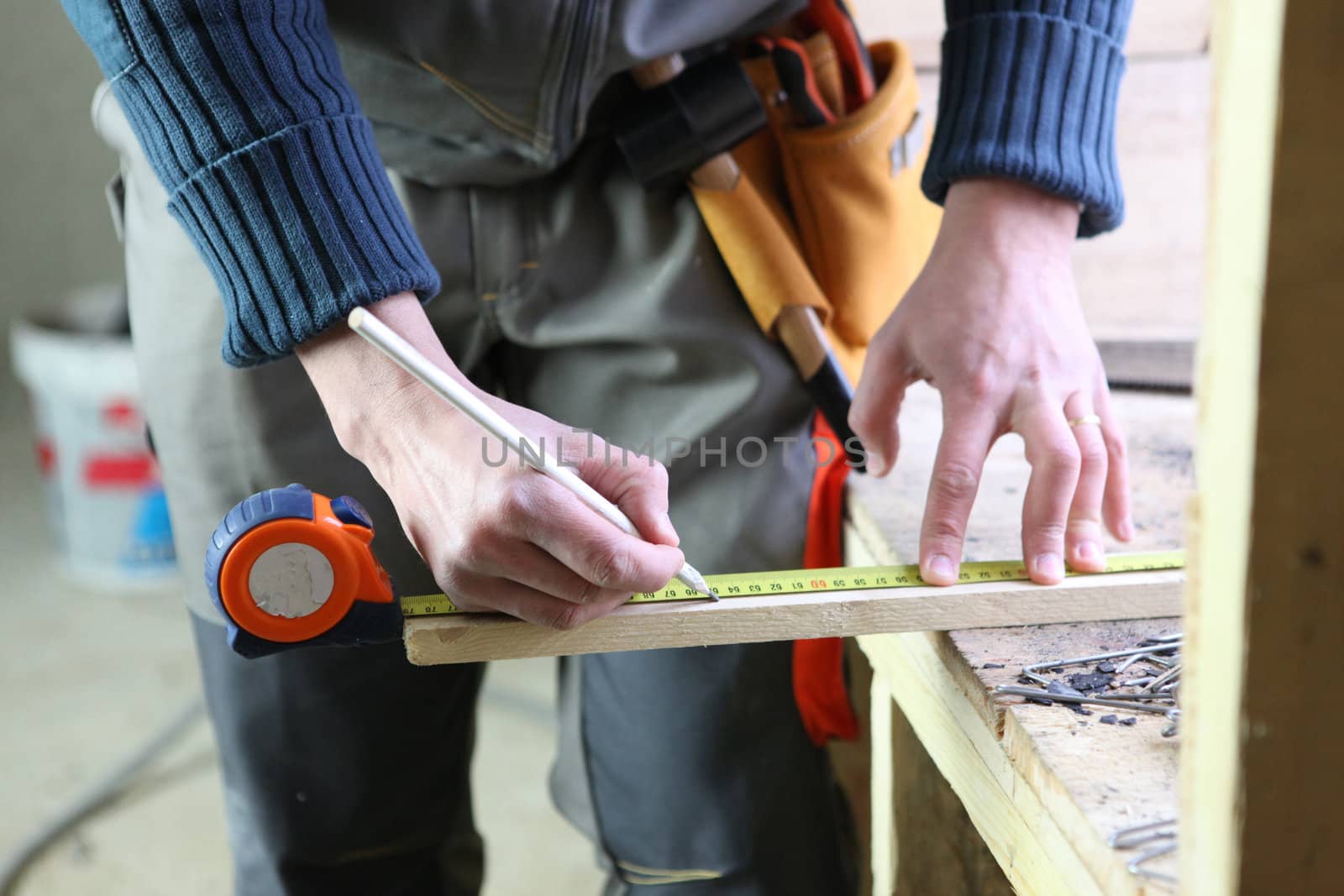 Joiner marking off plank of wood