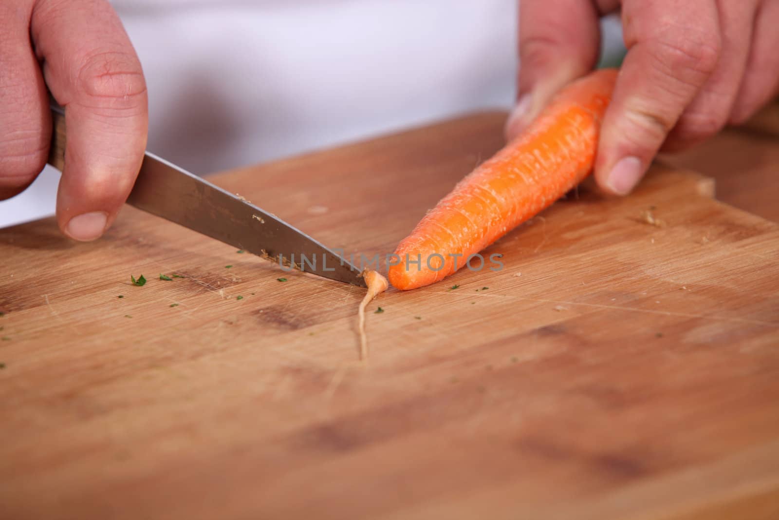 Chef slicing a carrot