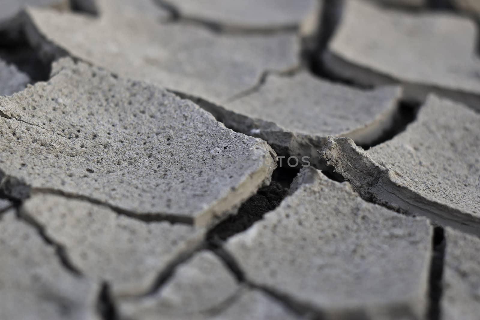 dry broken close up of mud by kjcimagery
