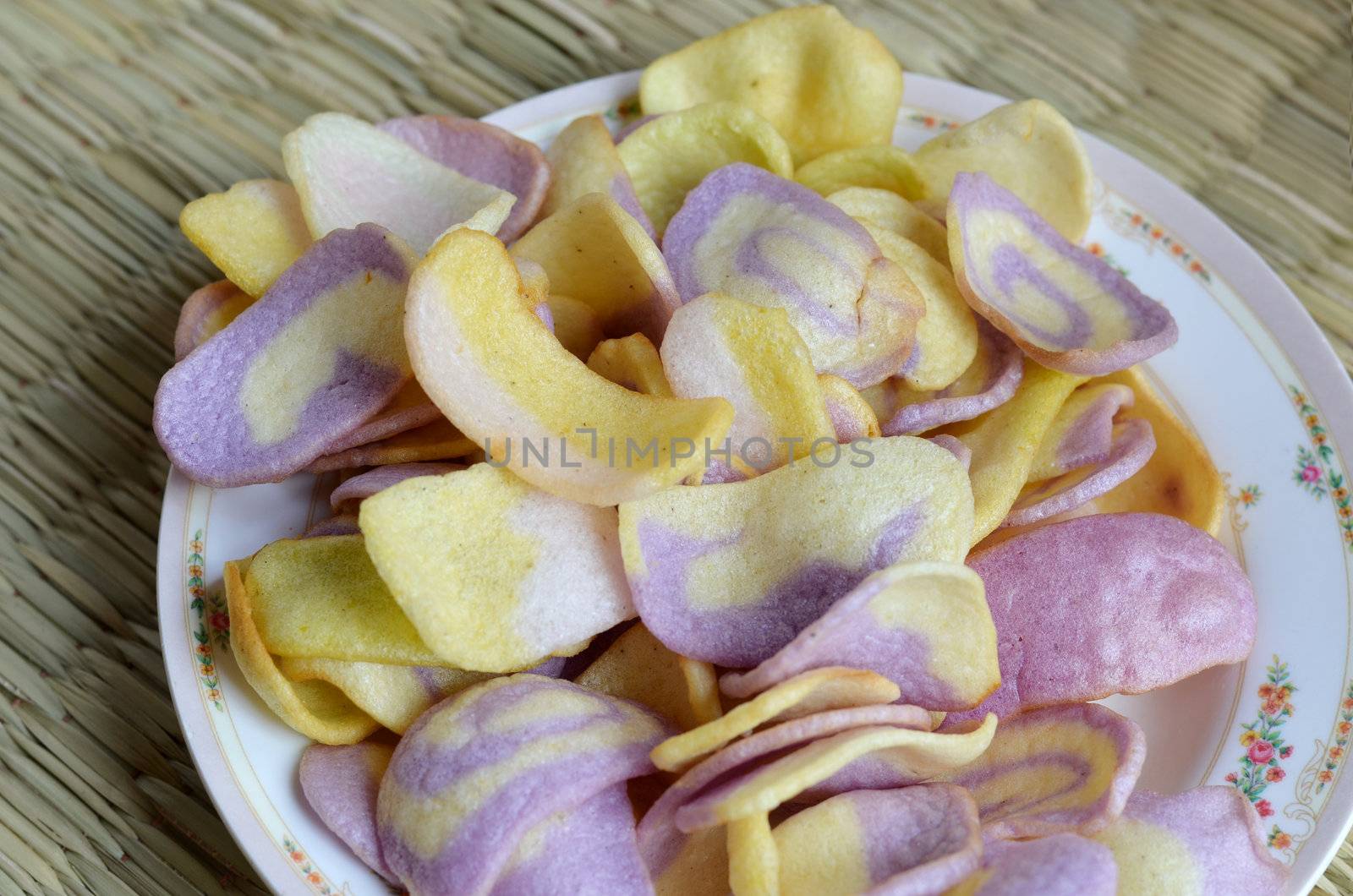 assorted  snacks ,  crispy rice  on dish .