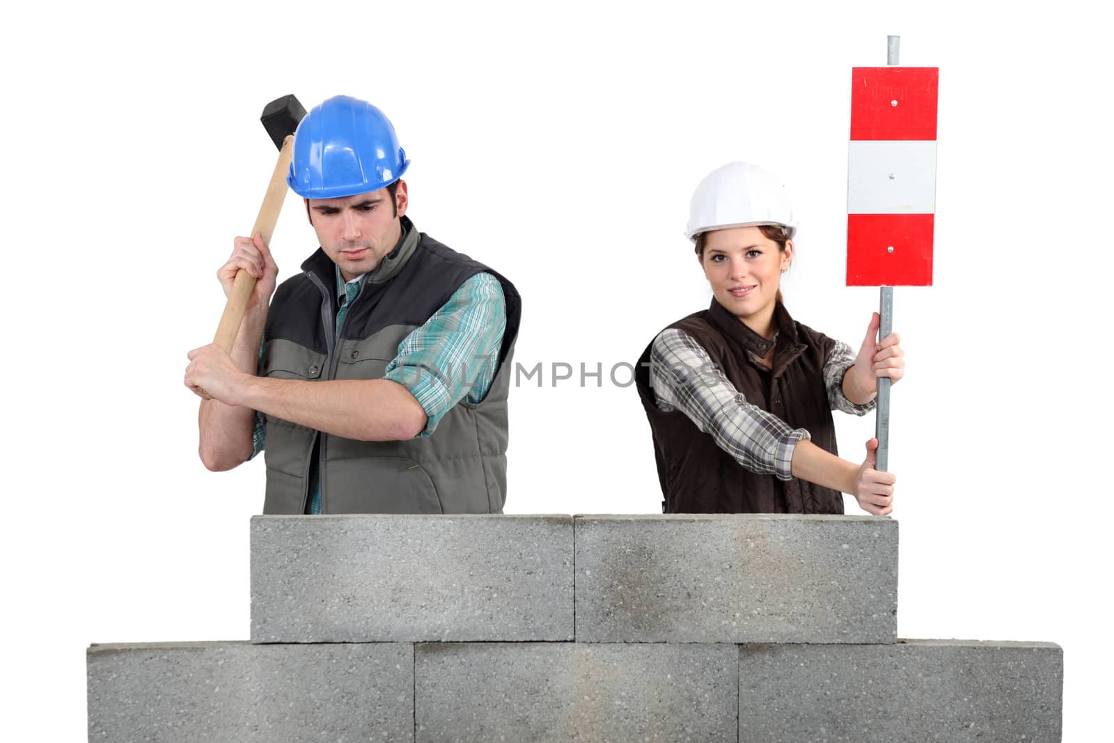 Man and woman working on wall