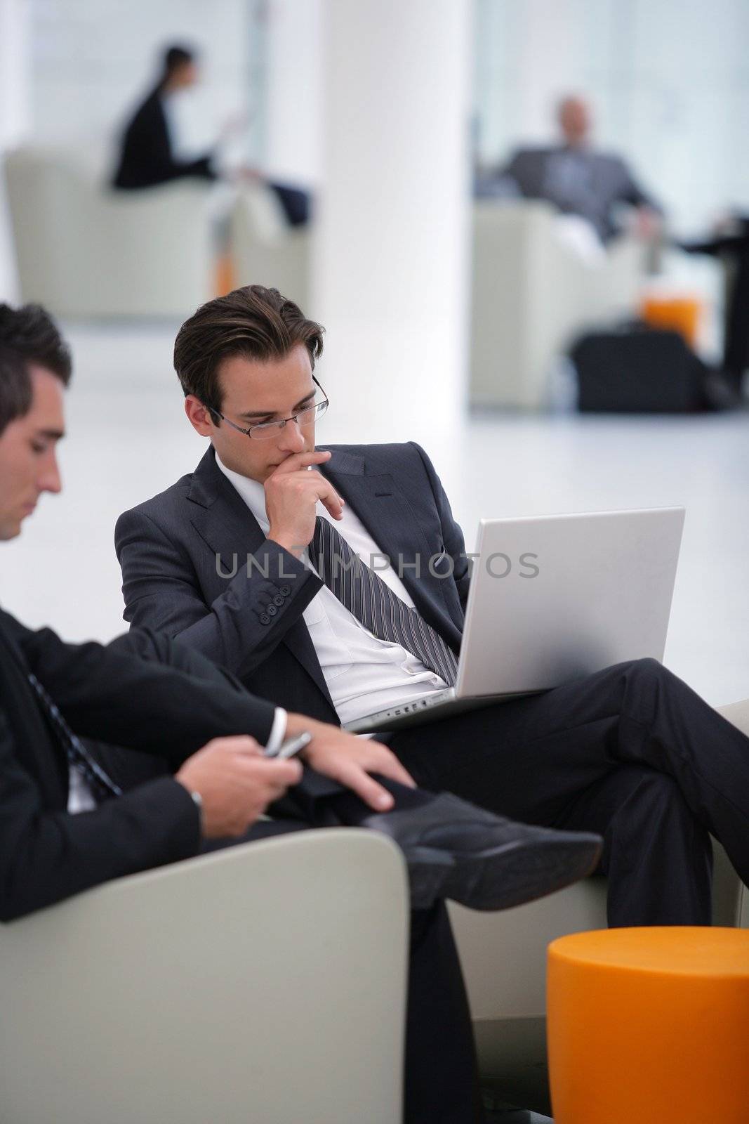 Businessmen waiting in airport lounge