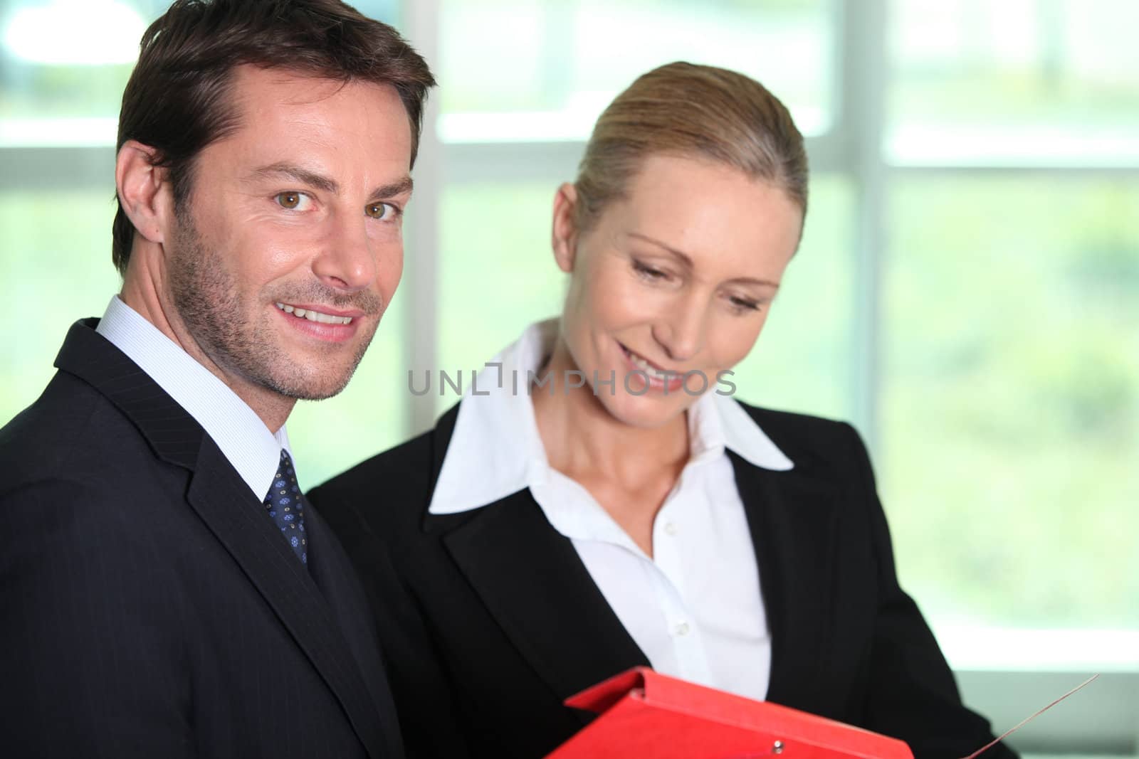 Businessman and woman with folder