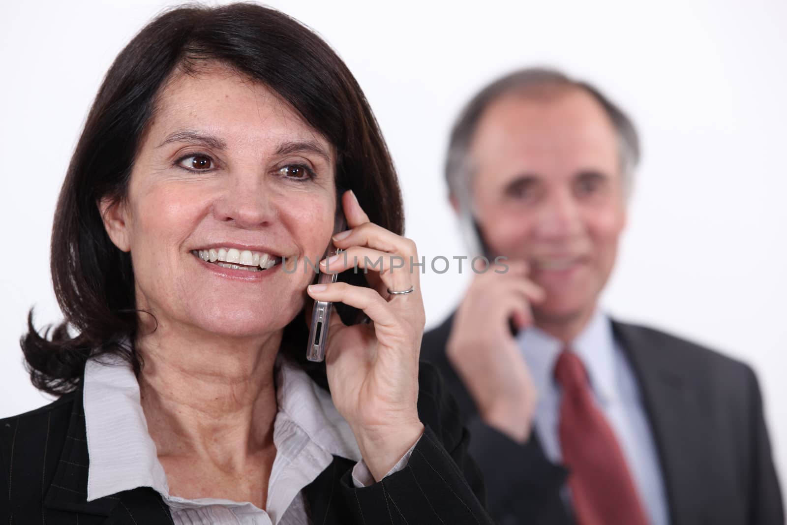 Mature businesswoman on a telephone by phovoir