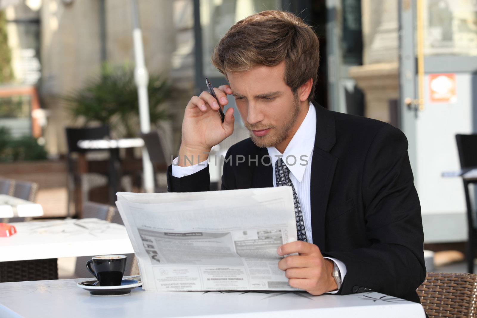 Man with newspaper and coffee