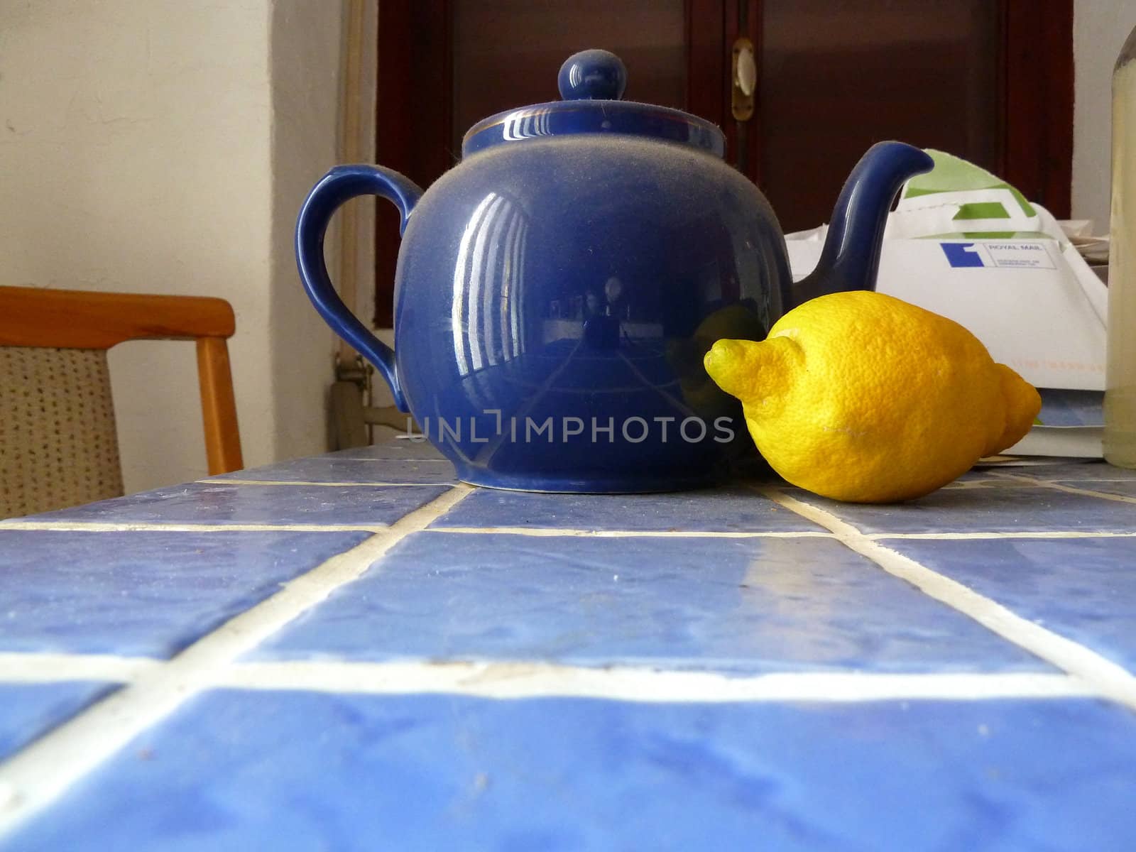 dusty blue teapot with a lemon as a background