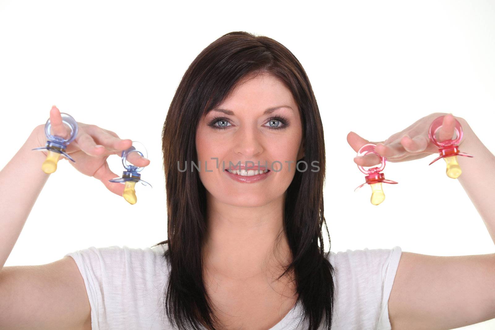 Woman brandishing pacifiers by phovoir