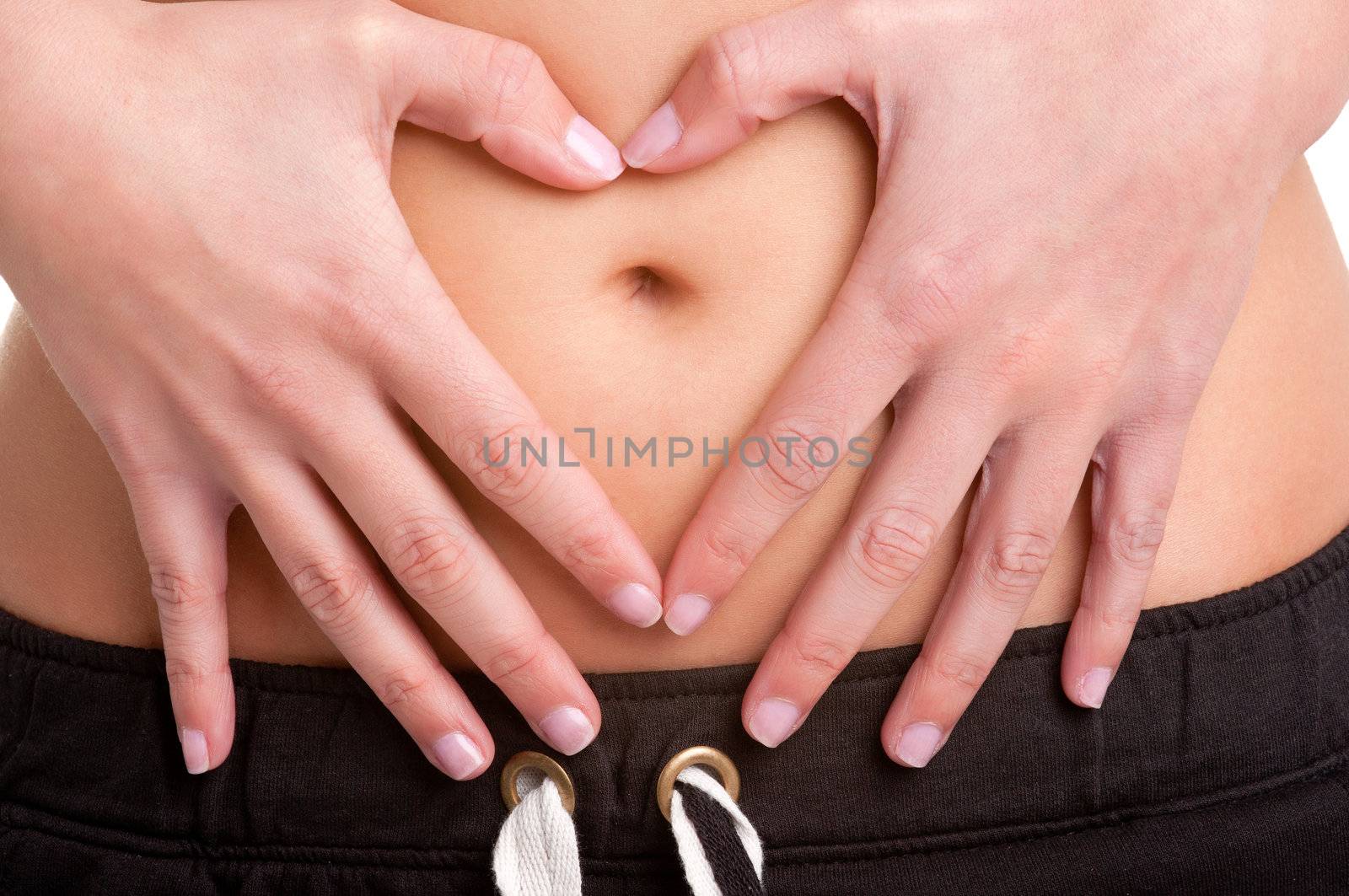 Woman Making a Heart Symbol over her Tummy by ruigsantos